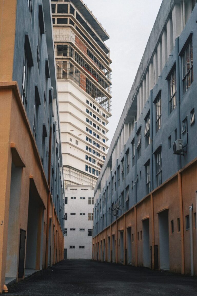 A view of modern architecture in Malacca with contrasting building colors and an urban vibe.