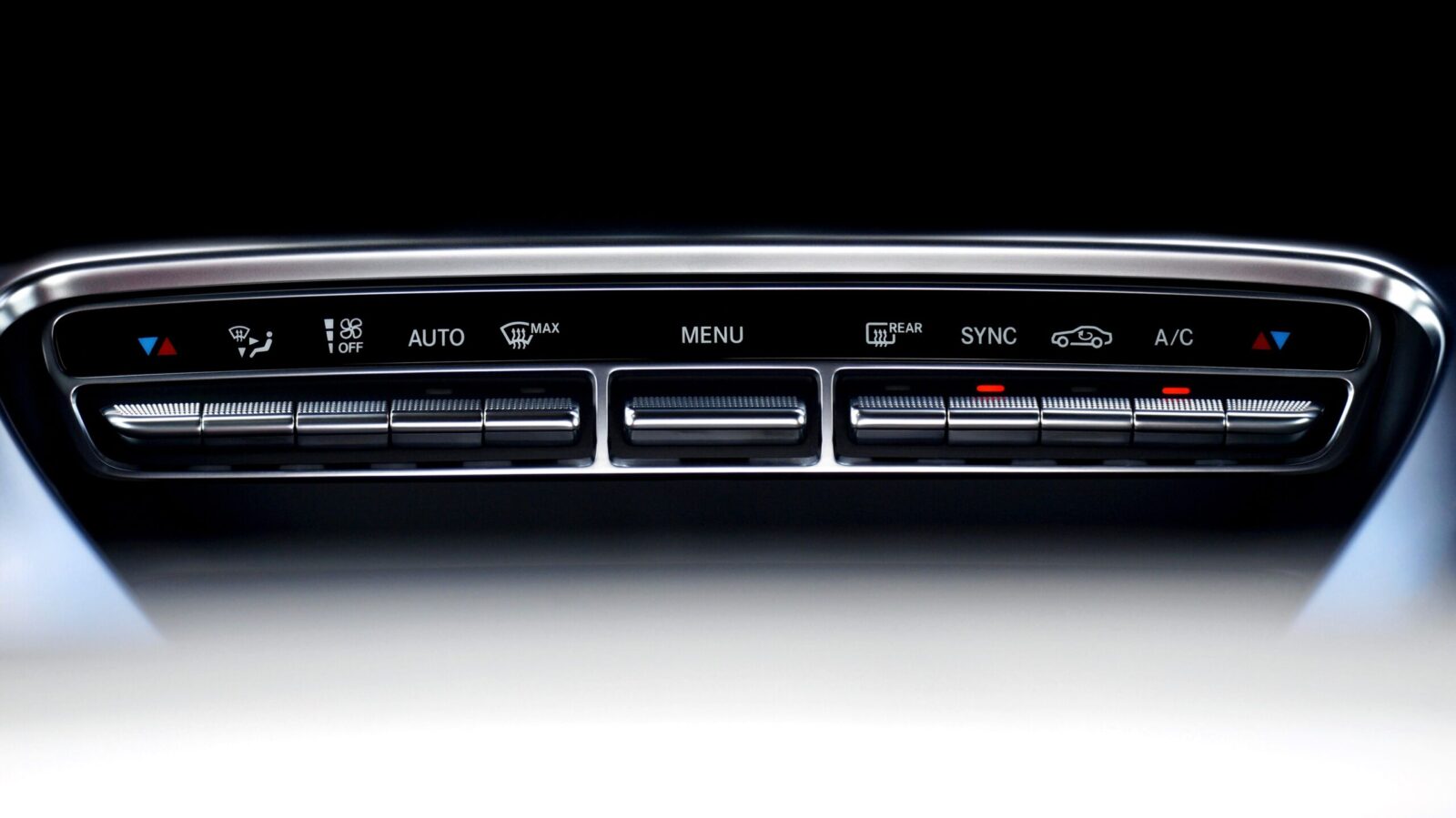 Close-up view of a sleek automotive dashboard climate control interface.